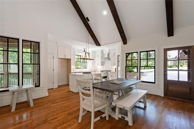 dining space featuring beamed ceiling, dark hardwood / wood-style floors, high vaulted ceiling, and a chandelier