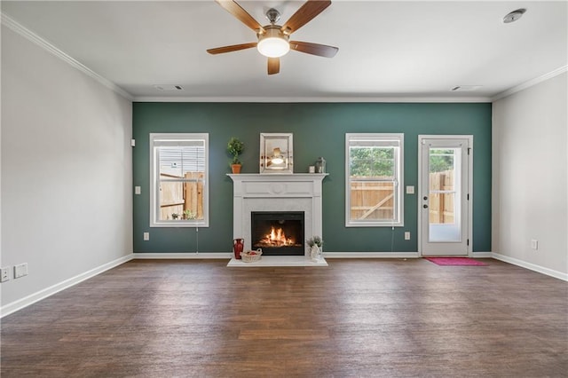 unfurnished living room featuring baseboards, a lit fireplace, crown molding, and wood finished floors