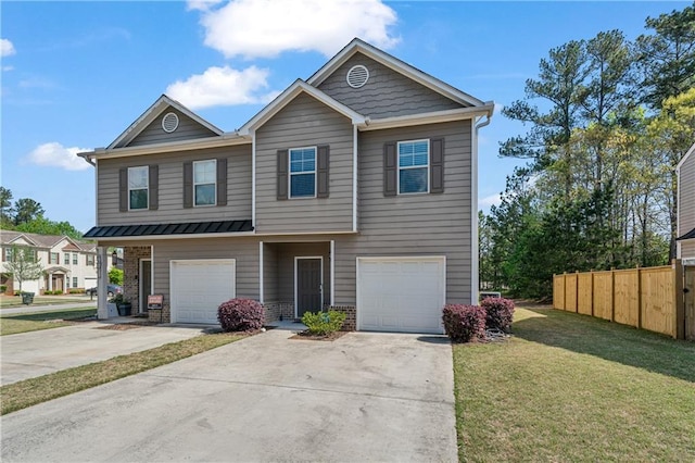townhome / multi-family property featuring a front yard, fence, a garage, and concrete driveway