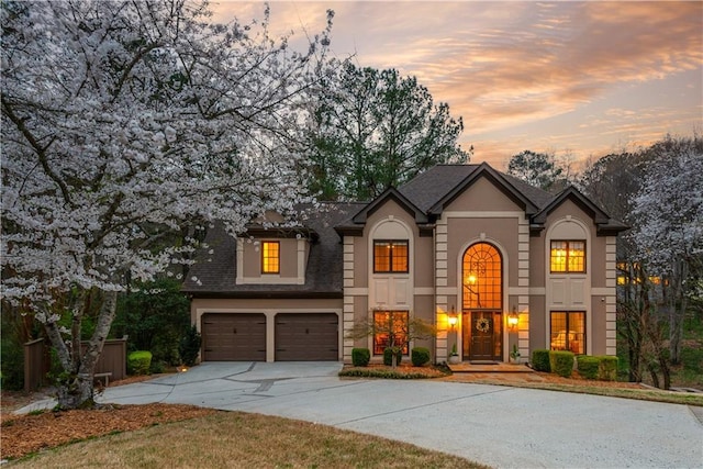 view of front of property featuring stucco siding, an attached garage, and concrete driveway
