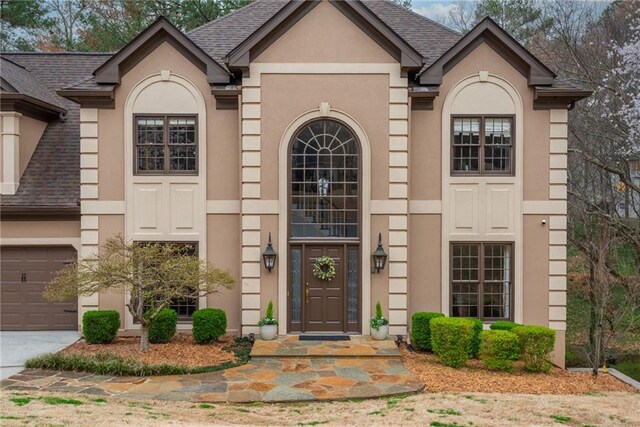 entrance foyer featuring stairs, crown molding, a high ceiling, wood finished floors, and arched walkways