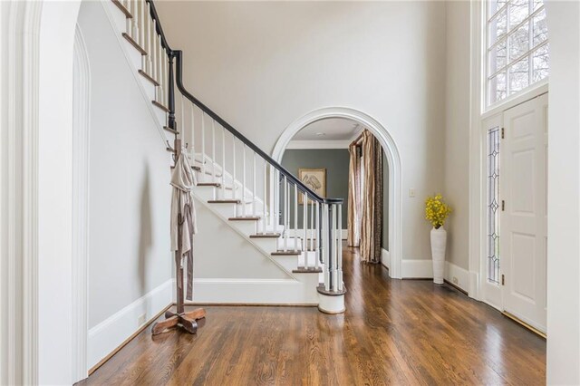 sitting room featuring baseboards, wood finished floors, and crown molding