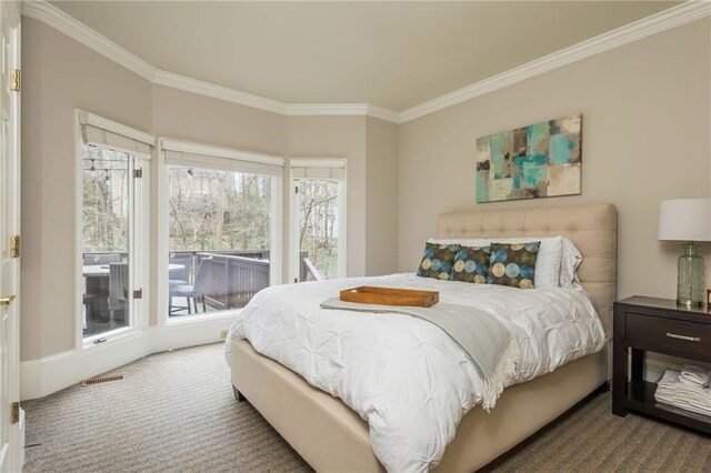 bedroom with light carpet and crown molding