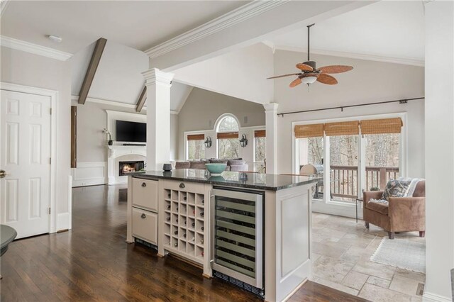 kitchen featuring a sink, beverage cooler, appliances with stainless steel finishes, and dark wood-type flooring