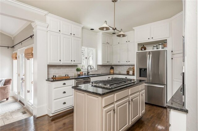 kitchen with dark stone counters, white cabinetry, a sink, and stainless steel appliances