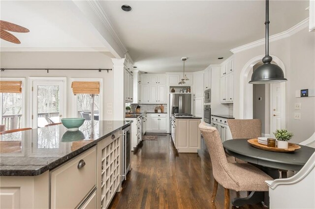 kitchen with dark wood-style flooring, ornamental molding, stainless steel appliances, tasteful backsplash, and open shelves