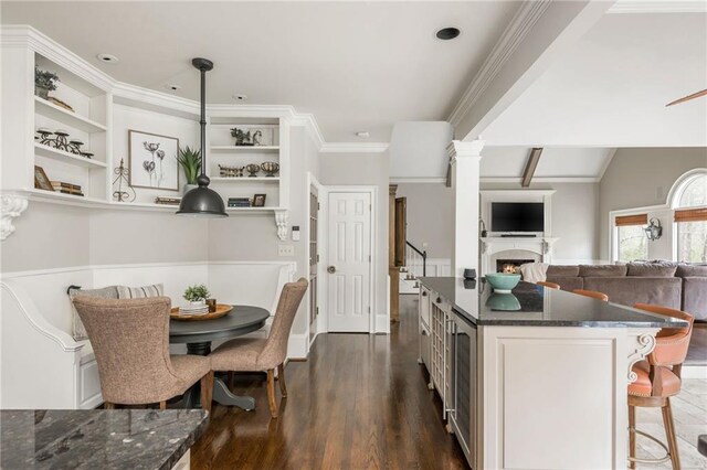 interior space with ceiling fan, wood finished floors, and a wealth of natural light