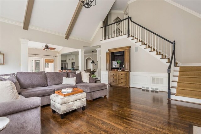 living room featuring visible vents, wood finished floors, stairway, and crown molding