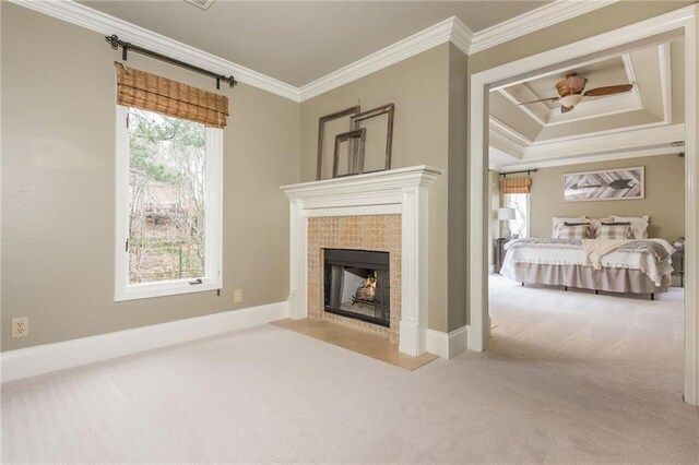 interior space featuring baseboards, a fireplace, carpet, and ornamental molding