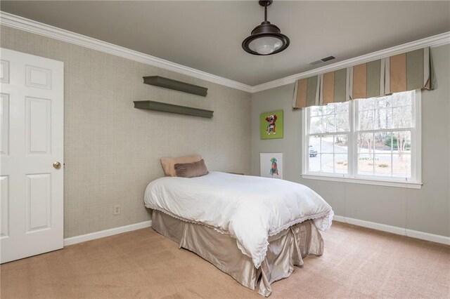 carpeted bedroom with baseboards, visible vents, and crown molding