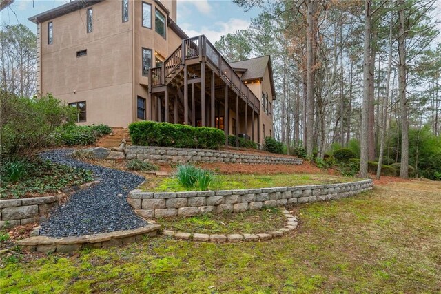 view of yard featuring stairway and a wooden deck