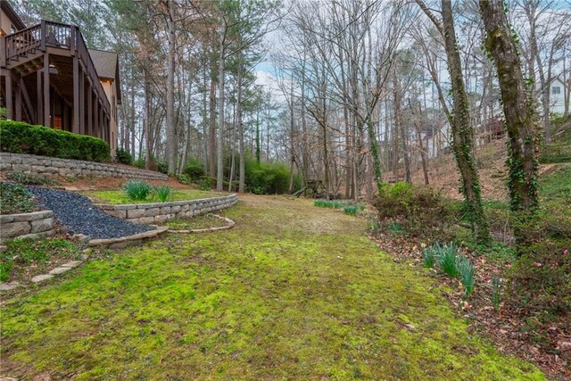 rear view of house with a wooden deck, a chimney, stairway, and a patio area