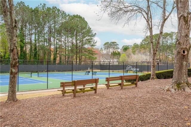 exterior space with a lawn, a tennis court, a gazebo, and fence