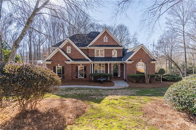 view of front facade featuring a front lawn and covered porch