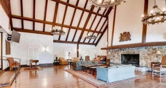 6851 Roswell Rd Unit 15, Atlanta, GA 30328 - living area featuring a high ceiling, a chandelier, wood finished floors, and a stone fireplace