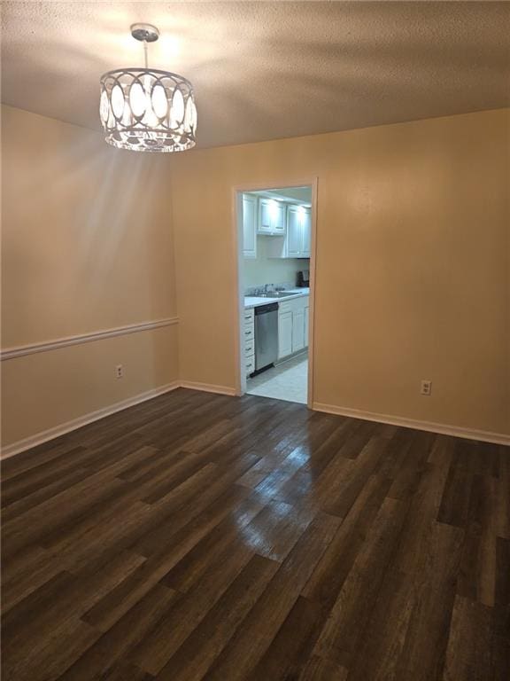 6851 Roswell Rd Unit 15, Atlanta, GA 30328 - unfurnished room featuring dark wood finished floors, a chandelier, and a textured ceiling