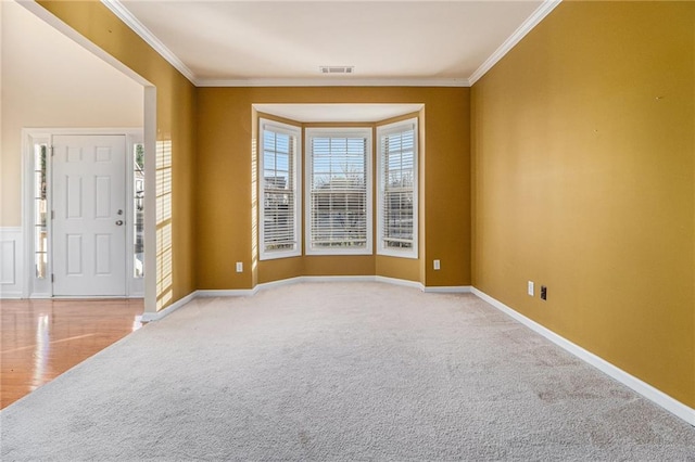 carpeted entrance foyer with ornamental molding