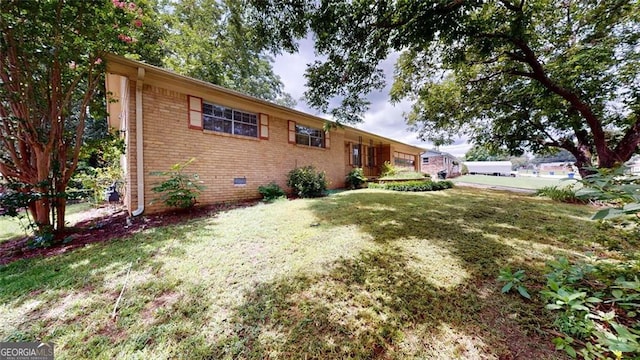 ranch-style home with crawl space, brick siding, and a front lawn