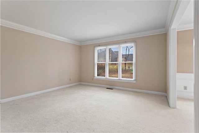 unfurnished room with visible vents, baseboards, light colored carpet, and crown molding