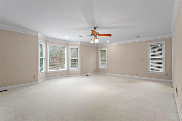 empty room featuring ornamental molding, recessed lighting, baseboards, light colored carpet, and ceiling fan