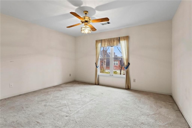 unfurnished room featuring visible vents, a ceiling fan, and carpet