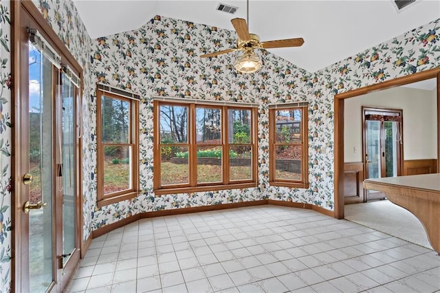 interior space with visible vents, wainscoting, vaulted ceiling, and wallpapered walls