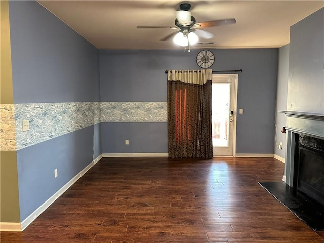 interior space with ceiling fan and dark hardwood / wood-style floors