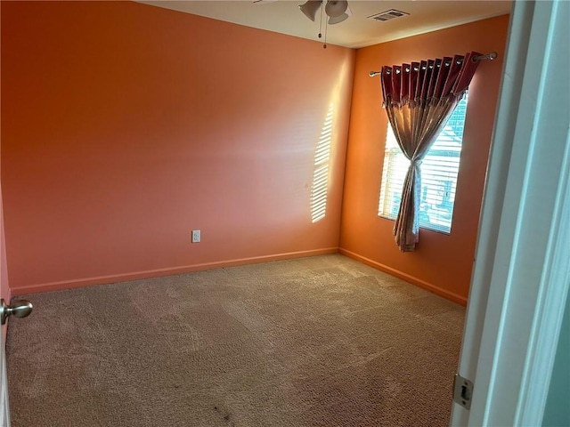 spare room with carpet flooring and ceiling fan