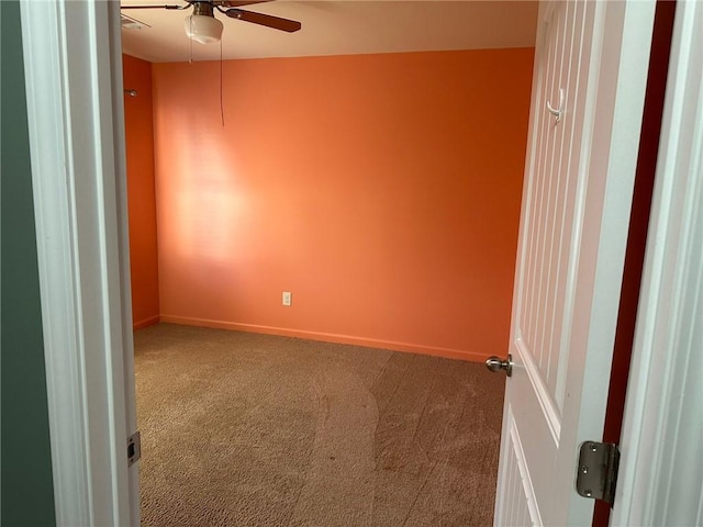 unfurnished room with ceiling fan and carpet floors