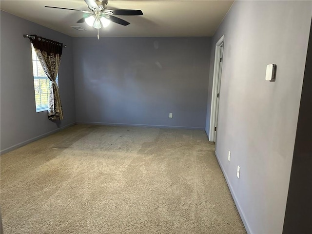 carpeted empty room featuring ceiling fan