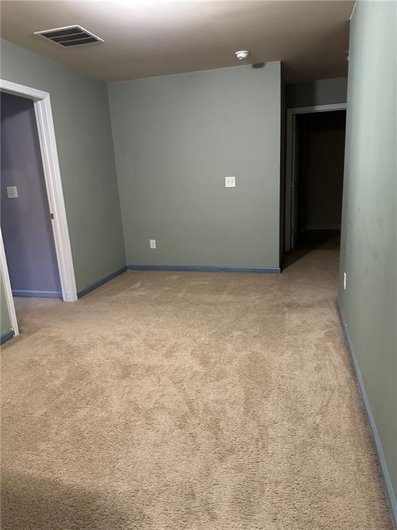 unfurnished room featuring light colored carpet