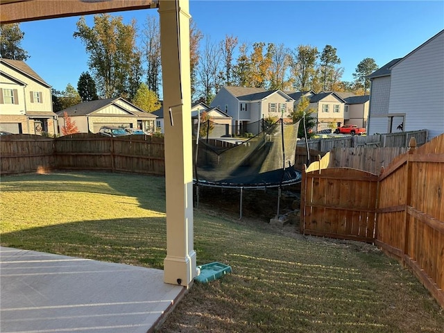 view of yard with a patio and a trampoline