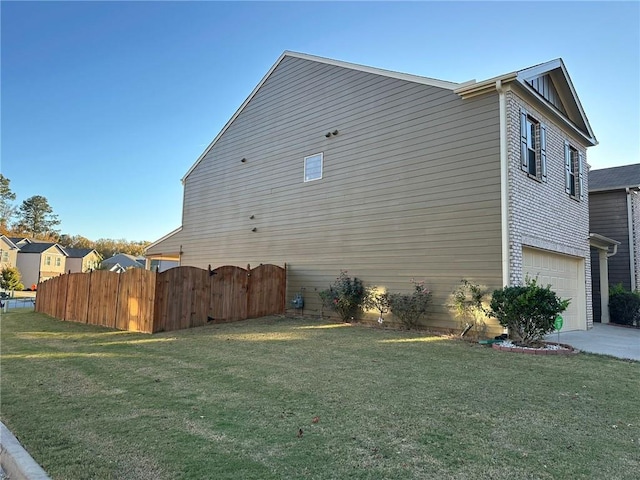 view of property exterior with a yard and a garage