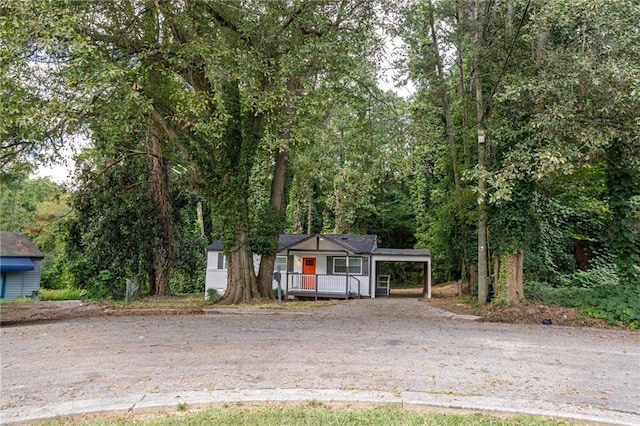 view of front of house with covered porch and a carport