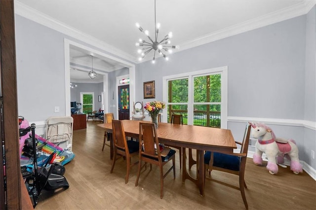9035 Walnut Cove Ct, Gainesville, GA 30506 - dining area featuring wood finished floors, ornamental molding, a chandelier, and plenty of natural light