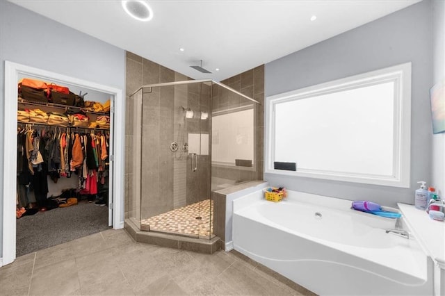 9035 Walnut Cove Ct, Gainesville, GA 30506 - bathroom featuring a stall shower, a bath, a walk in closet, and tile patterned flooring