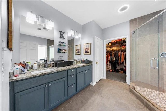 9035 Walnut Cove Ct, Gainesville, GA 30506 - full bath with a stall shower, double vanity, a walk in closet, tile patterned floors, and baseboards