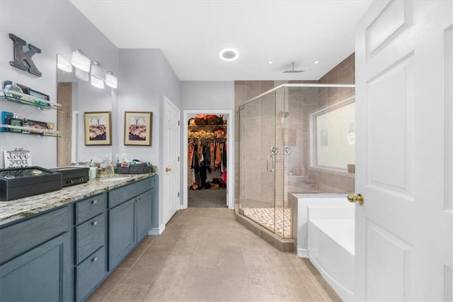 9035 Walnut Cove Ct, Gainesville, GA 30506 - bathroom featuring a shower stall, a garden tub, vanity, and a walk in closet