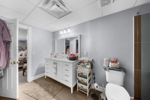 9035 Walnut Cove Ct, Gainesville, GA 30506 - ensuite bathroom featuring a drop ceiling, tile patterned floors, vanity, toilet, and baseboards