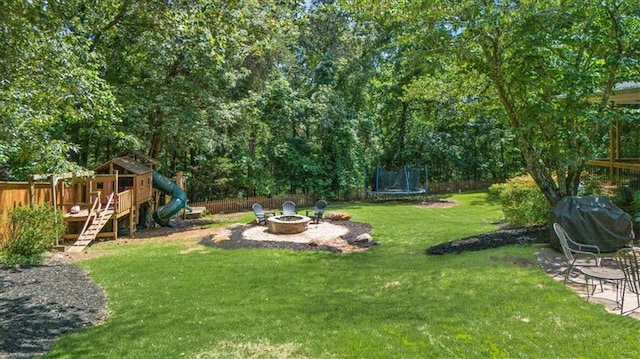 9035 Walnut Cove Ct, Gainesville, GA 30506 - view of grassy yard with a fire pit, a trampoline, and a playground