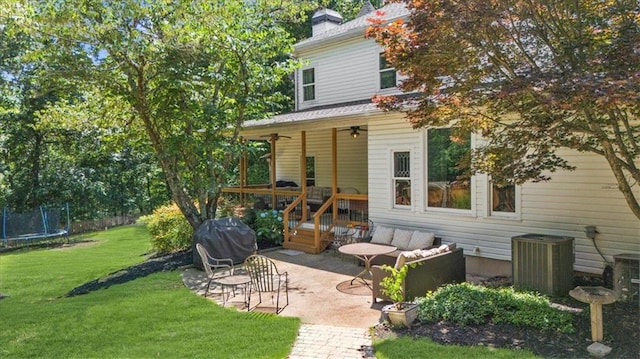 9035 Walnut Cove Ct, Gainesville, GA 30506 - back of house featuring a trampoline, a patio area, a ceiling fan, a yard, and a chimney