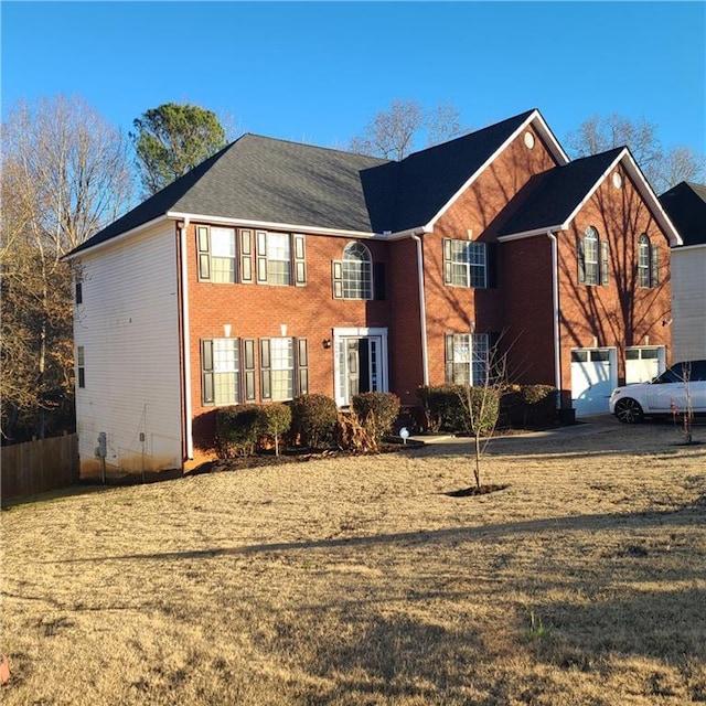 colonial-style house with brick siding and fence