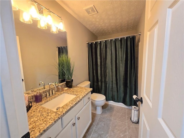 bathroom featuring a textured ceiling, toilet, vanity, visible vents, and tile patterned floors