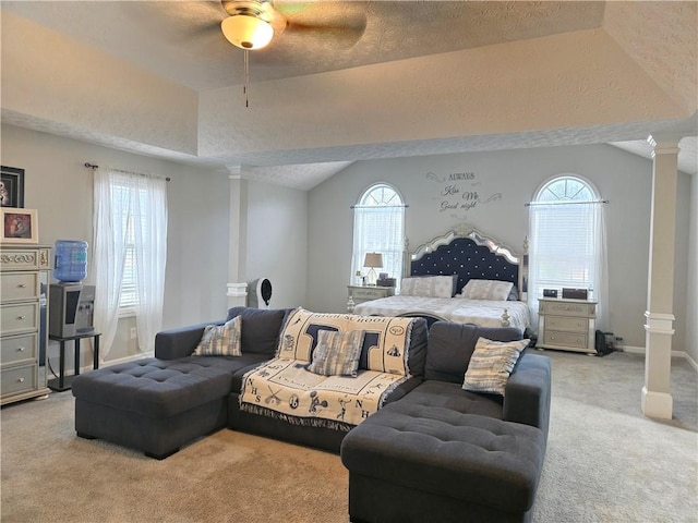 bedroom with ornate columns, multiple windows, vaulted ceiling, and carpet flooring