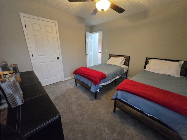 carpeted bedroom with a ceiling fan, a textured ceiling, and baseboards