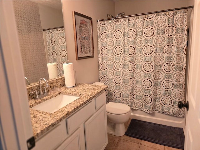 bathroom featuring tile patterned flooring, vanity, toilet, and shower / bath combo with shower curtain