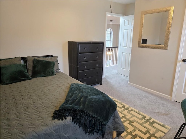 carpeted bedroom featuring baseboards