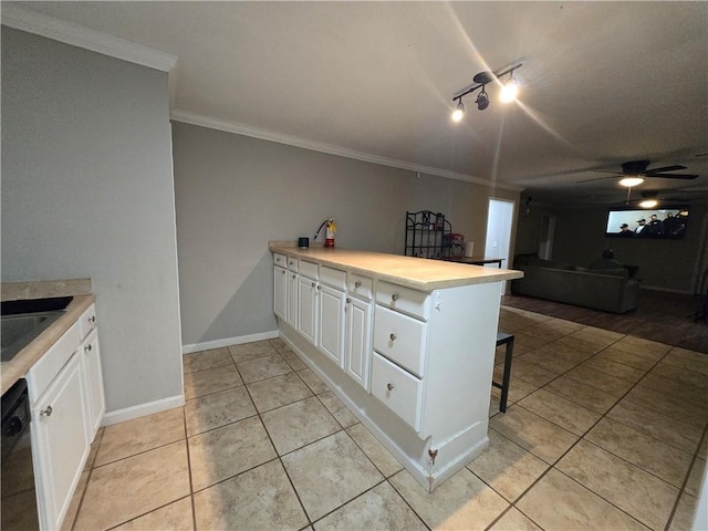 kitchen with a breakfast bar area, a peninsula, white cabinetry, black dishwasher, and light countertops