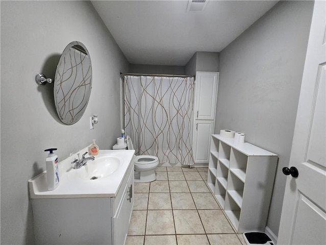 bathroom with toilet, tile patterned flooring, visible vents, and vanity