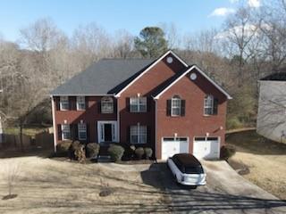 colonial house with a garage and driveway